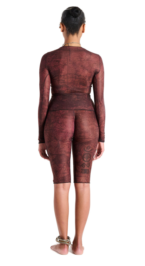 Gianni Capri in Earth, back view highlighting sculpted waist and hip contour with thigh tattoo design