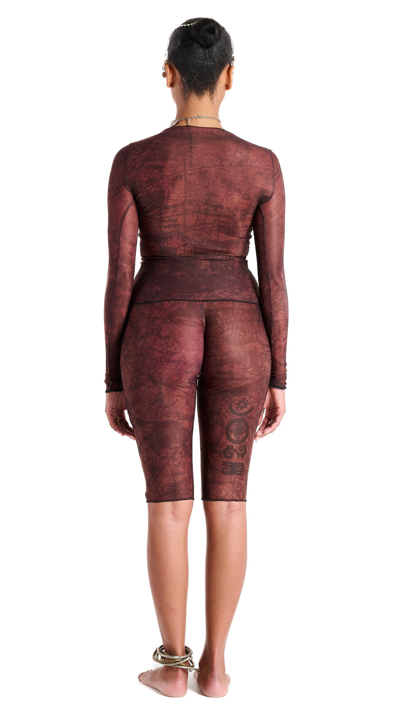 Gianni Capri in Earth, back view highlighting sculpted waist and hip contour with thigh tattoo design