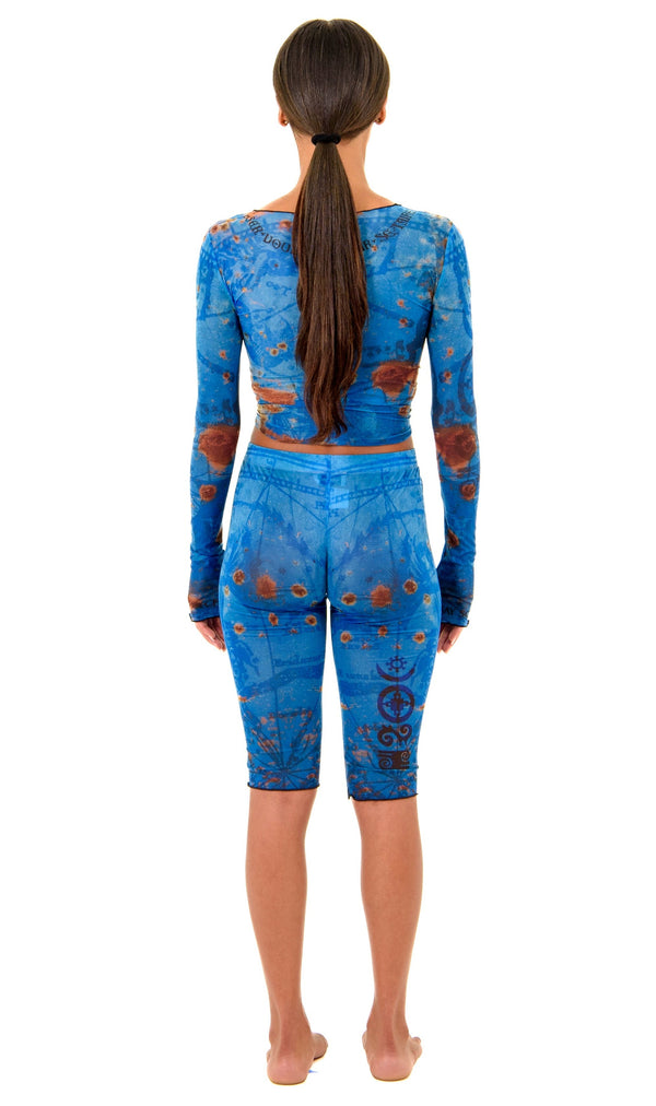 Gianni Capri in Ocean, back view highlighting sculpted waist and hip contour with thigh tattoo design