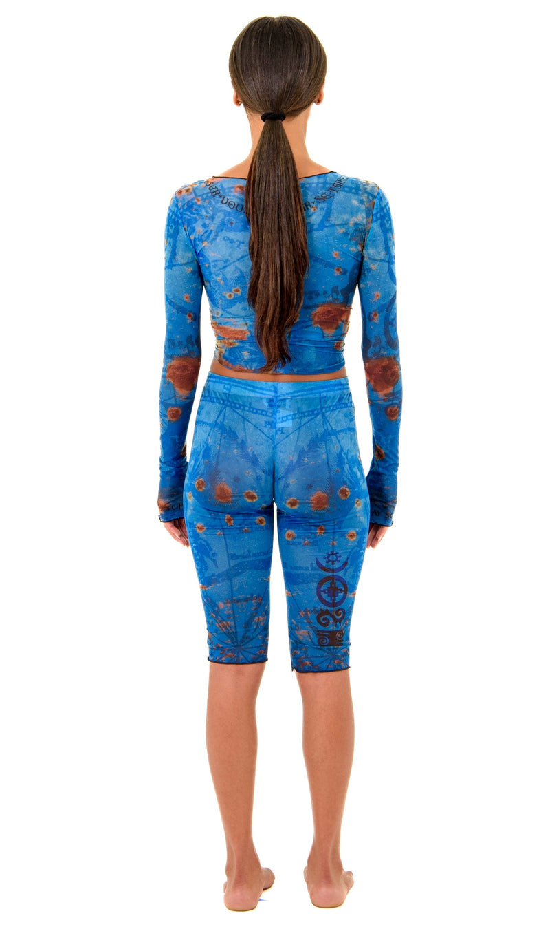 Gianni Capri in Ocean, back view highlighting sculpted waist and hip contour with thigh tattoo design